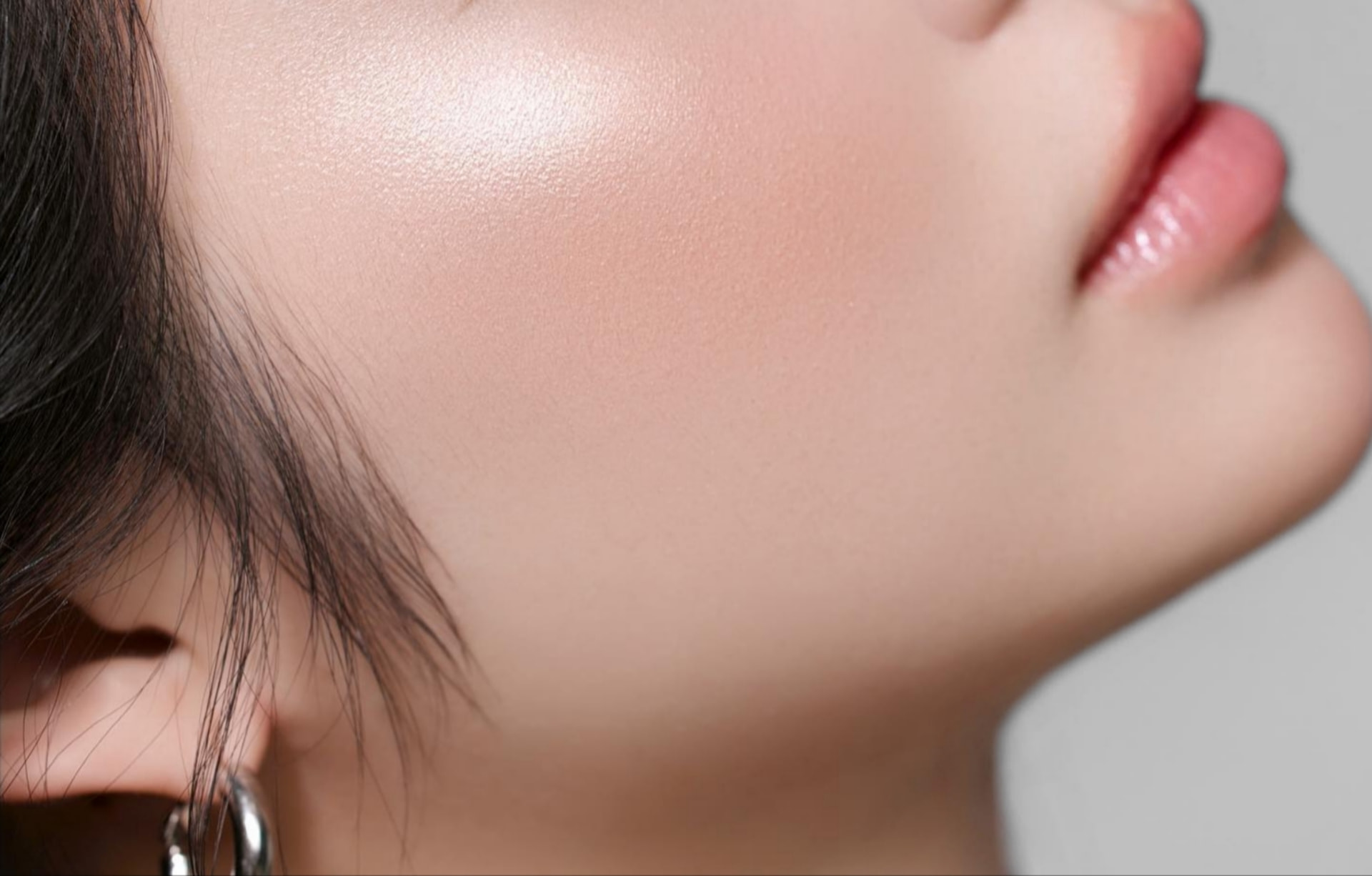 Luminous skin catching the light across a cheekbone